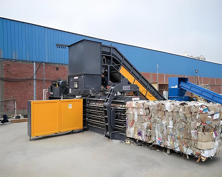 How does a hydraulic waste material baler work?